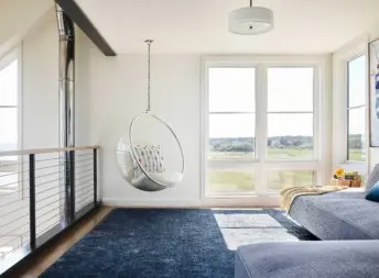 House on the Bluff Hero Interior Loft Space Living Lounge Steel Beam Hanging Chair