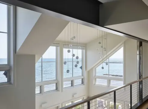 House on the Bluff Hero Interior Loft Water View Oceanfront Bubble Lights Steel Beam Modern Contemporary 2022 12 16 124500 afwx