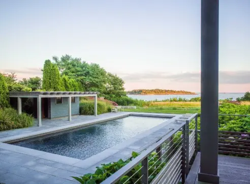 Inside Out Hero Exterior Pool House Pool Cable Railing Stone Landscape Deck Coastal View reduced 2022 12 16 124651 kube